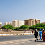 Modern Djibouti City**

"A wide shot of Djibouti City's skyline, showcasing modern architecture alongside traditional buildings, fully clothed people walking on the sidewalks, appropriate attire, safe for work, real estate development, perfect anatomy, natural proportions, professional photography, high quality, daytime, modest, family-friendly."

**